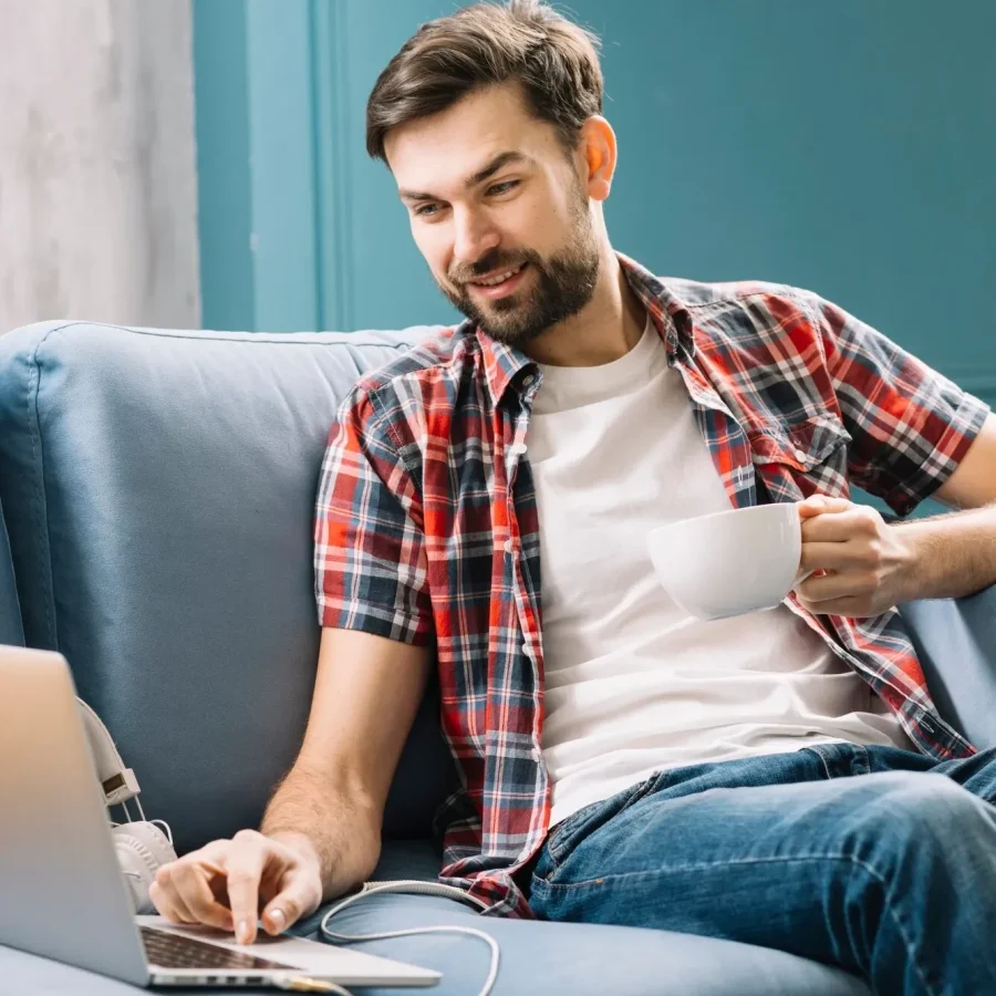 man-drinking-using-laptop_23-2147800016